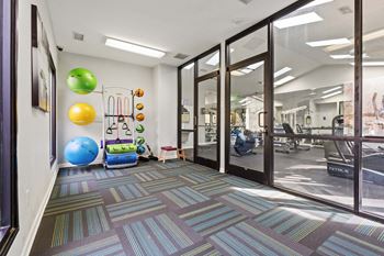 A room with a blue exercise ball and a green exercise ball on the floor. at Woodland Park Apartment Homes, North Carolina, 27455